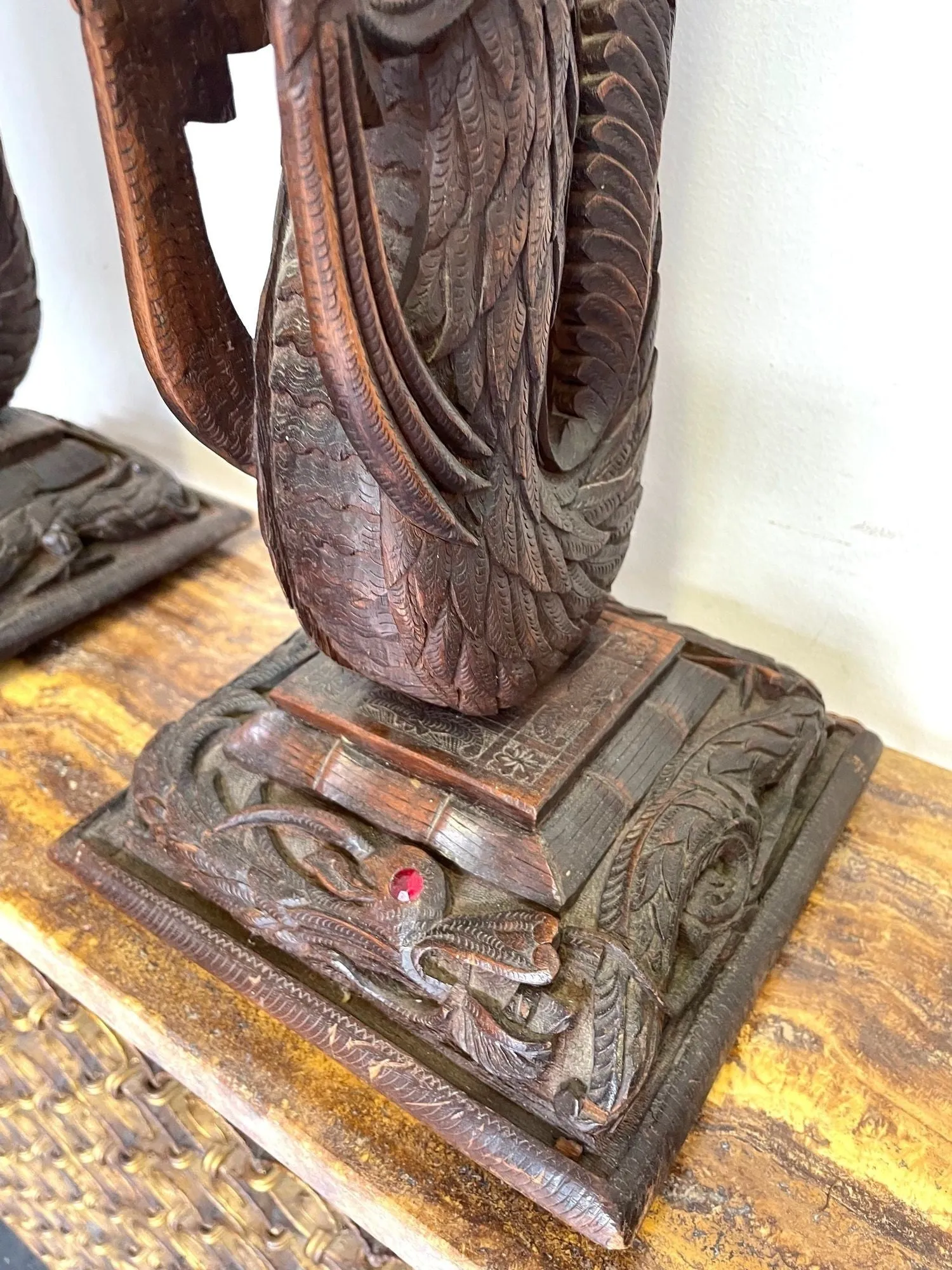 A pair of intricately carved Burmese dragon lamps each mounted on carved wooden base.