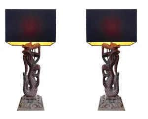 A pair of intricately carved Burmese dragon lamps each mounted on carved wooden base.