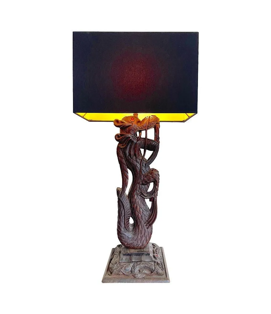 A pair of intricately carved Burmese dragon lamps each mounted on carved wooden base.