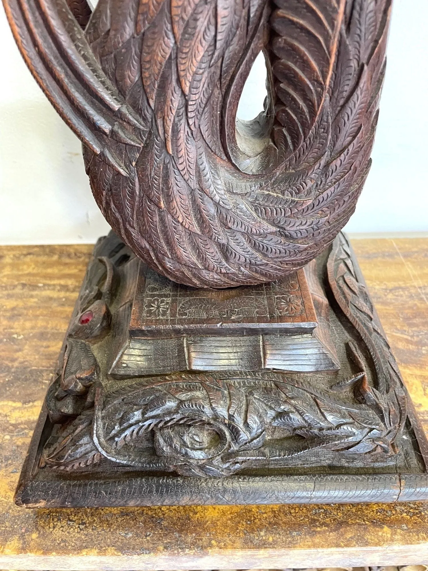 A pair of intricately carved Burmese dragon lamps each mounted on carved wooden base.