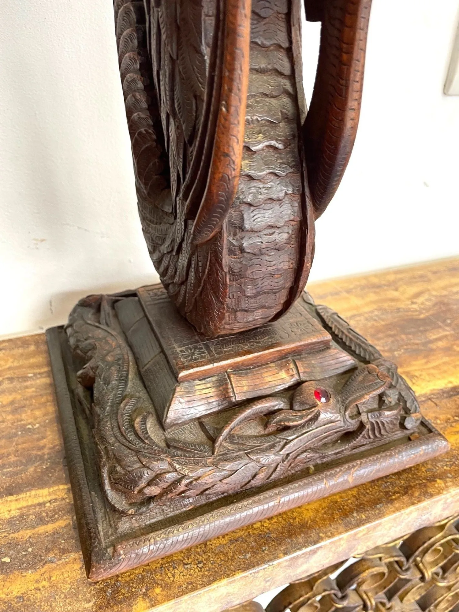 A pair of intricately carved Burmese dragon lamps each mounted on carved wooden base.