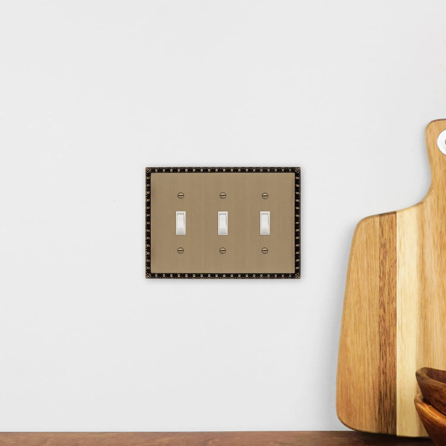 Egg & Dart Switch Plate with Triple Toggle in Antique Brass